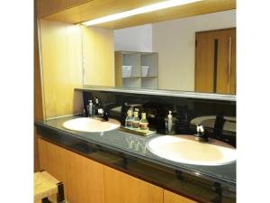 a bathroom with two sinks and a large mirror at Hotel AreaOne Chitose - Vacation STAY 96133v in Chitose +13 photos