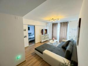 a living room with a couch and a table at Sunrise Apartments City Center in Bucharest