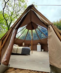 a tent with a bed in the middle at Les nuits de Cassiopee in Sorde-lʼAbbaye
