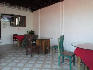 a dining room with tables and chairs in a room at Hotel Contadora in Contadora