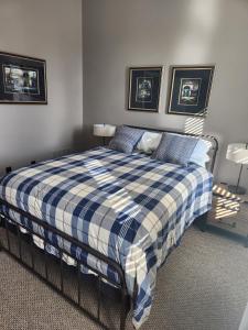 a bedroom with a bed with a blue and white plaid blanket at Schwartz Castle in Columbus
