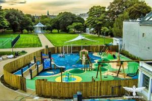 a playground in a park with a water park at The Little Red Door in Warrenpoint