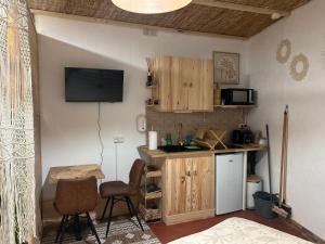 a kitchen with a small table and a counter top at Le PALAWAN in Perpignan