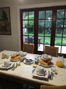 a table with plates of food on top of it at Chambre d'hôtes de Dompierre in Le Quesnoy-en-Artois