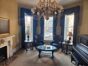a living room with a chandelier and a table and chairs at Schwartz Castle in Columbus