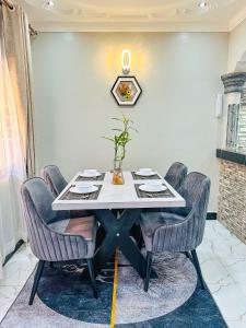 a dining room with a table and chairs at Comfort homes BnB in Kampala +16 photos