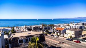 an aerial view of a city and the ocean at Luxury Ocean View Condo Steps To The Sand VIEWS in Manhattan Beach