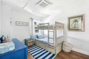 a room with a bunk bed and a desk at Luxury Ocean View Condo Steps To The Sand VIEWS in Manhattan Beach