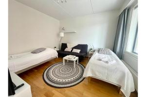 a small room with a bed and a couch at Kotiyksiö Vaughan in Lahti