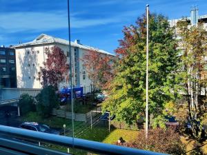 a reflection of a building and trees in a window at Spacious and bright 2 bedroom apartment in Oulu