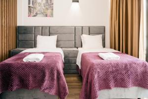 Łóżko lub łóżka w pokoju w obiekcie Hotel Lajka Luxury