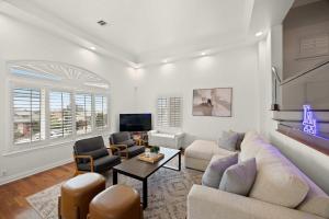 Una sala de estar con un sofá y sillas y un televisor. en New Listing Dodger Clubhouse by Colby & Conrad, en Los Ángeles