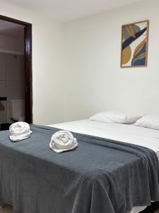 a bed with two white towels on top of it at Hotel Paraiso Natal - EXPRESS in Natal