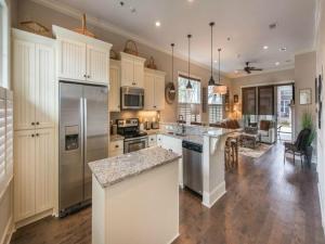 a large kitchen with white cabinets and a counter top at Garden Cottage 08 in Jekyll Island