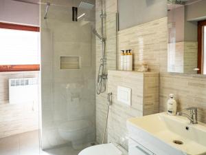 a bathroom with a shower and a toilet and a sink at Andar's People in Sarajevo +83 photos