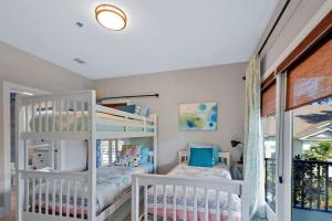 a bedroom with two bunk beds and a window at Garden Cottage 08 in Jekyll Island +33 photos