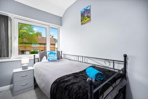 Ένα ή περισσότερα κρεβάτια σε δωμάτιο στο The Relocation Haven - Birmingham