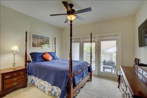 a bedroom with a bed and a ceiling fan at Garden Cottage 09 in Jekyll Island +51 photos