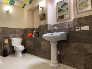 a bathroom with a sink and a toilet at Casa Bella Vista Zufre in Zufre +24 photos