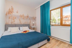 Postel nebo postele na pokoji v ubytování Apartamenty nad morzem Mierzeja Wiślana Mikoszewo + 2 fotografie