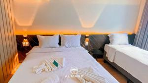 a hotel room with two beds with towels on them at Setai Yacht Premium - By Almare Flats in João Pessoa