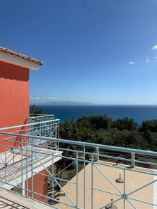 a balcony with a view of the ocean at Villa Georgia in Lourdhata