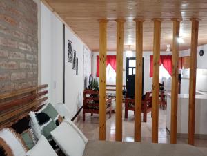a living room with a couch and a dining room at Loma Pora in Oberá