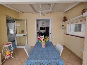 a dining room table with a vase of flowers on it at Da Papi Johnny in Maratea