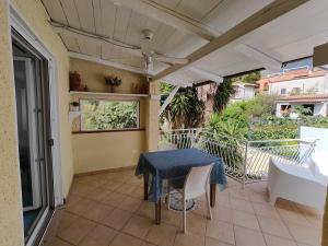 a patio with a table and chairs on a balcony at Da Papi Johnny in Maratea