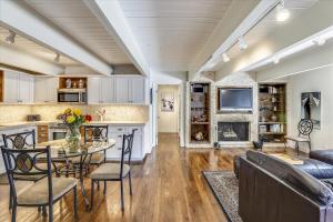 a kitchen and living room with a table and chairs at Walk Everywhere! Deluxe Aspen Condo in Aspen