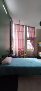a bedroom with a large bed and a window at Guest house. Shared room in panoramic apartment. Private bathroom. Kitchen and washmachine in Huaraz