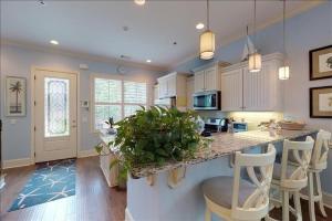 a large kitchen with a island with a counter top at Garden Cottage 23 in Jekyll Island