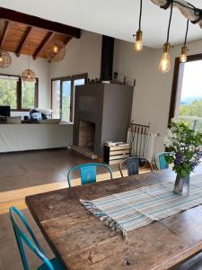 a dining room with a wooden table and a fireplace at Casa soñada frente a las montañas in San Carlos de Bariloche