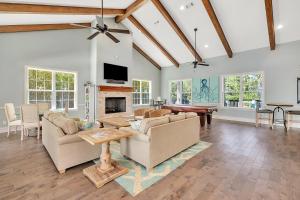 a living room with two couches and a fireplace at Poolside Cottage 32 in Jekyll Island