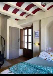a bedroom with a bed with a red and white striped ceiling at Casa Bella Vista Zufre in Zufre