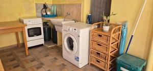 a laundry room with a washing machine and a microwave at NONNA ADRIANA in Terrasini