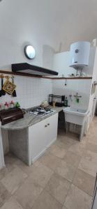 a kitchen with a stove and a sink in it at NONNA ADRIANA in Terrasini