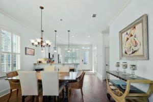 a dining room and kitchen with a table and chairs at Ocean Cottage 44 in Jekyll Island
