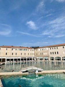 a large building with a large pool of water at Casa Maria Saturnia in Saturnia