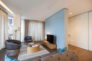 a living room with a couch and a tv at Dukley Hotel & Resort in Budva