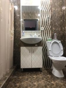 a bathroom with a toilet and a sink at Syune Syunick Shinuhayr in Shinuhayr +29 photos