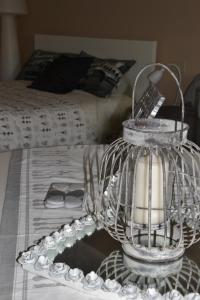 a bird cage sitting on top of a table with a bed at Il Sentiero Del Cuore B&B in Ravenna