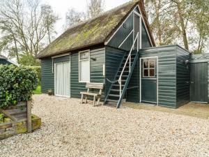 a blue tiny house with a ladder on it at Cottage in Dwarsgracht near Giethoorn in Giethoorn