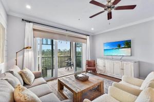 a living room with a couch and a table at Moorings 104 in Jekyll Island