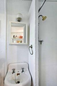 a white bathroom with a sink and a window at Brice Sea Shell Stay in Jekyll Island +12 photos