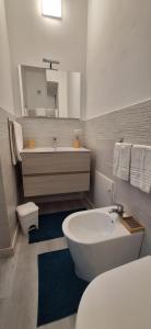 a bathroom with a tub and a sink and a toilet at Casa Nicolò in Mazzeo +22 photos