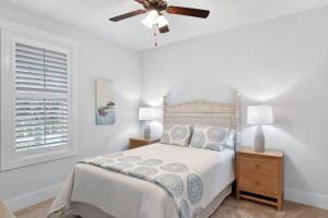 a bedroom with a bed and a ceiling fan at Moorings 206 in Jekyll Island +19 photos