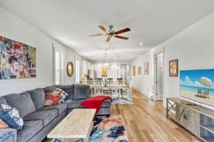 a living room with a gray couch and a table at Moorings 107 in Jekyll Island
