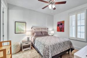 a bedroom with a bed and a ceiling fan at Moorings 107 in Jekyll Island +22 photos