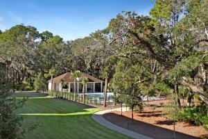 a house with a swimming pool in a park at Moorings 107 in Jekyll Island